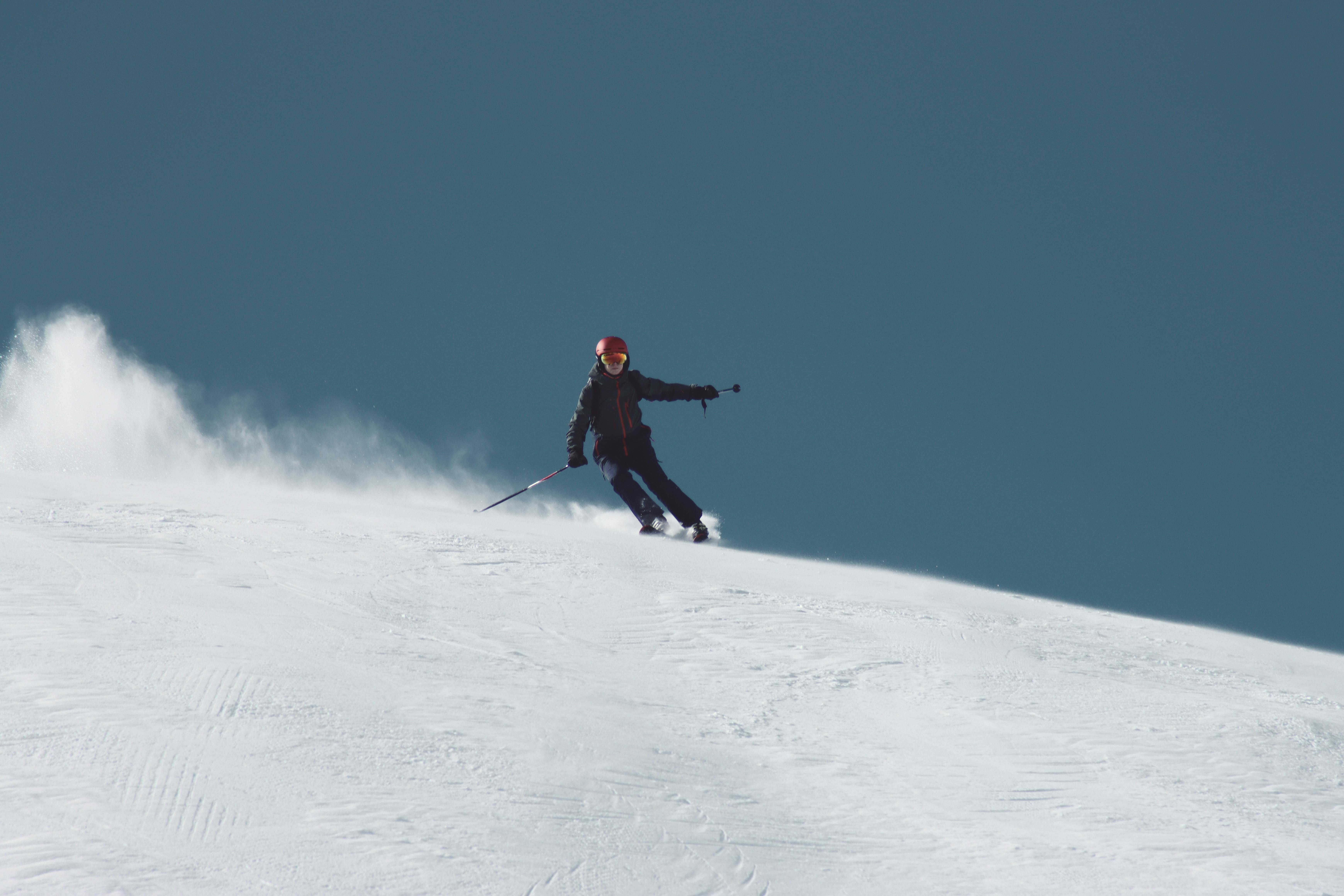 Skier skiing on a snowy maintain slope
